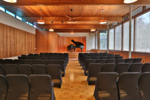 mid-century modern event hall with Steinway on stage